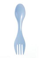 Blue plastic spork combining a spoon and fork in one utensil,isolated on a white background. for camping or outdoor use photo