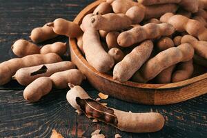 Pile of fresh tamarind fruits in shell photo