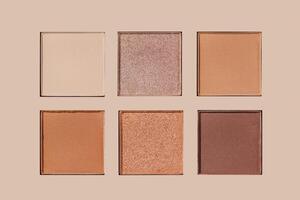 Eyeshadow neutral palette, mix of glitter, matte shades in beige, brown, red warm hues. Minimal top view pattern for beauty, makeup, cosmetic themes, Textured swatches eyeshade or highlighter refills photo