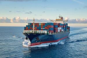Large container ship sailing on the open ocean at sunset. photo