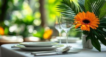 A table setting with a flower in a vase photo