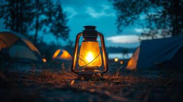 A campfire lit up in the dark with tents in the background photo