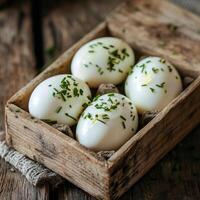 Four hard boiled eggs in a wooden box photo