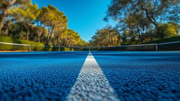 A tennis court with a white line on it photo