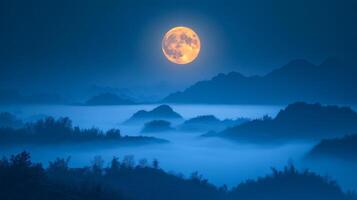 A full moon is seen over a mountain range at night photo