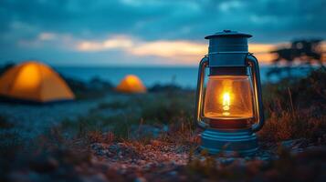A lantern is lit up in the middle of a field photo