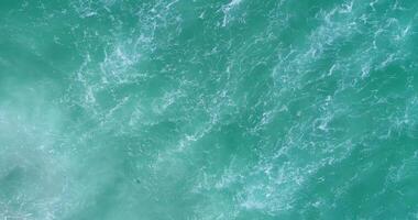 aerial footage, directly above view of the waves on the shore of a beach, concept sea water texture background video