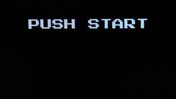 Retro gaming start screen with pixelated text. 8 bit console video