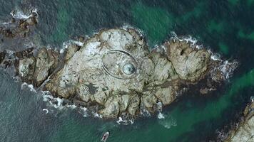 rocky island and lighthouse Top down drone view video