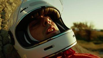 Tired Astronaut With Helmet Breathing Heavy On A Rock In Hostile Planet video