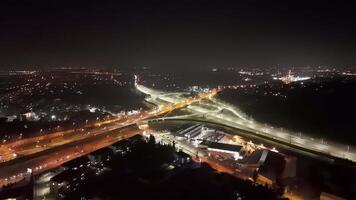 Aerial view of illuminated highway at night, Aerial shot of a large highway intersection brightly illuminated at night, video