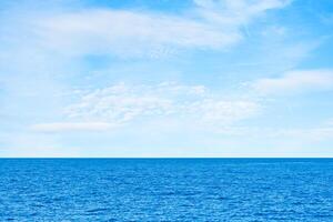 Blue sea and white clouds on sky. Water cloud horizon background. Feeling calm, cool, relaxing. The idea for cold background and copy space on the top. the ocean deep indigo photo