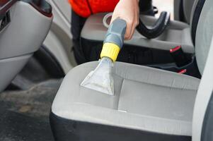 car dry cleaning. Light gray textile seats chemical cleaning with professionally extraction method. regular clean up photo