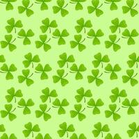 Seamless pattern of individual shamrock leaves on a light green background for St. Patrick's Day vector
