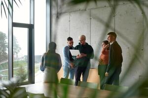 A diverse multiethnic business team engages in a collaborative meeting, discussing strategies and solutions in a modern office setting photo