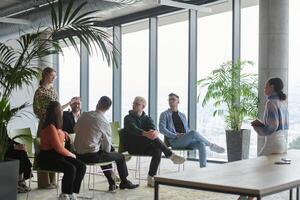A diverse group of business professionals sits attentively in a modern office, actively participating in a training session led by an instructor, focusing on the latest technological advancements in photo