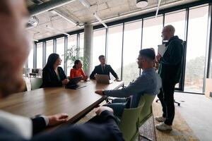 A diverse multiethnic business team engages in a collaborative meeting, discussing strategies and solutions in a modern office setting photo