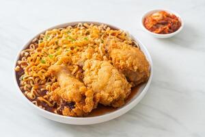 Korean instant noodles with fried chicken or Fried chicken ramyeon in white plate photo