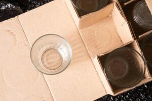 Overhead View of an Empty Glass on Cardboard Packaging photo