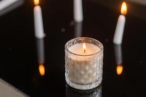 Cozy Candlelight on Reflective Surface photo