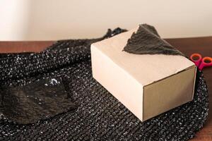 Cardboard Box Wrapped in Black Bubble Wrap photo