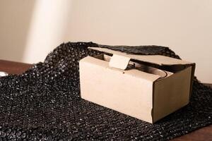 Open Cardboard Box on Textured Black Surface photo