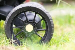Close-up of a Stroller Wheel on Grass photo