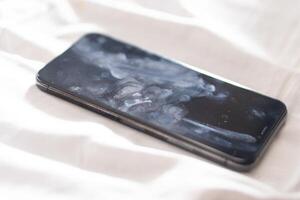 Close-up of a Smudged Smart phone on Soft Surface photo