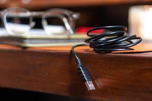 A black cord on a desk photo