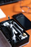 A black case with a cell phone, a pen, and a pair of scissors photo