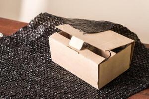 Partially Opened Cardboard Box on Black Surface photo