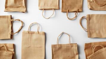 Minimalistic flat lay of ecofriendly shopping textile cotton bags isolated on background with text space, brown textile cotton bags for recycle shopping bag photo
