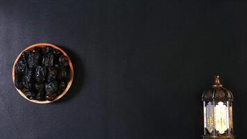 Dates Fruit on A Wooden Plate with A Lantern Decoration photo
