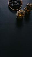 A Plate of Dates and Two Lanterns on Black Background photo