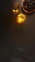 A Plate of Dates With Two Lighted Lanterns on Black Background photo
