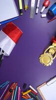 School Stationery with Notebook and Wooden Board Isolated on Purple Background and Copy Space. Back to School Concept photo
