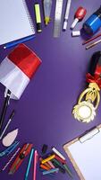 School Stationery with Notebook and Wooden Board Isolated on Purple Background with Blank Area for Copy Space. Back to School Concept photo