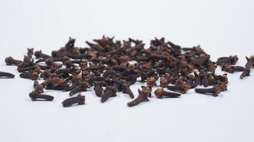 Scattered Dried Cloves with Selective Focus Isolated on White Background photo