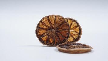 Slices of Dried Lemon on White Background photo