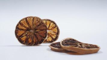 Slices of beautiful Dried Lemon on White Background photo
