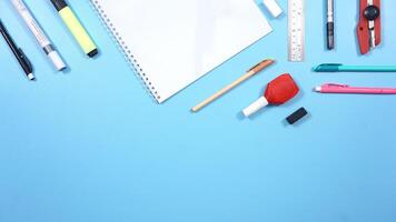 School Stationery and Notebook with Copy Space Area on Blue Background photo