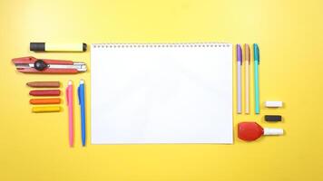 School Stationery and Notebook on Yellow Background photo