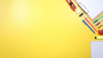 School Stationery, Notebook, and Wooden Clip Board with Copy Space on Yellow Background photo