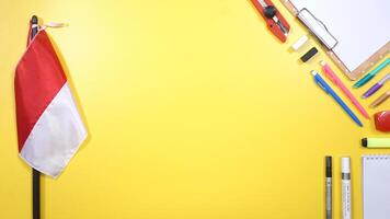 School Stationery, Backpack, and Wooden Clip Board with Copy Space Area in the middle on Yellow Background photo