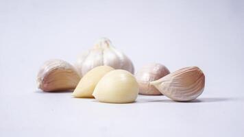 Fresh Peeled Garlic Cloves with Selective Focus on White Background photo
