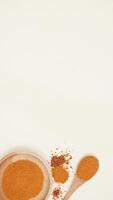 Chili Flakes, Chili Powder on Wooden Plate and Spoon on Light Background photo