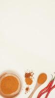 Raw Chili, Chili Flakes, Chili Powder on Wooden Plate and Spoon with Copy Space on Light Background photo