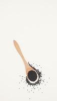 Black Cumin Spice on Wooden Spoon on Light Background with Copy Space photo