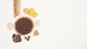 Cinnamon, Dried Lemon, Cloves, Star Anise, Cardamom, Coriander, Turmeric, Candlenut on Light Background photo