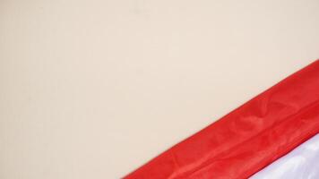 Indonesia Red and White Flag with Copy Space Area on Light Background photo